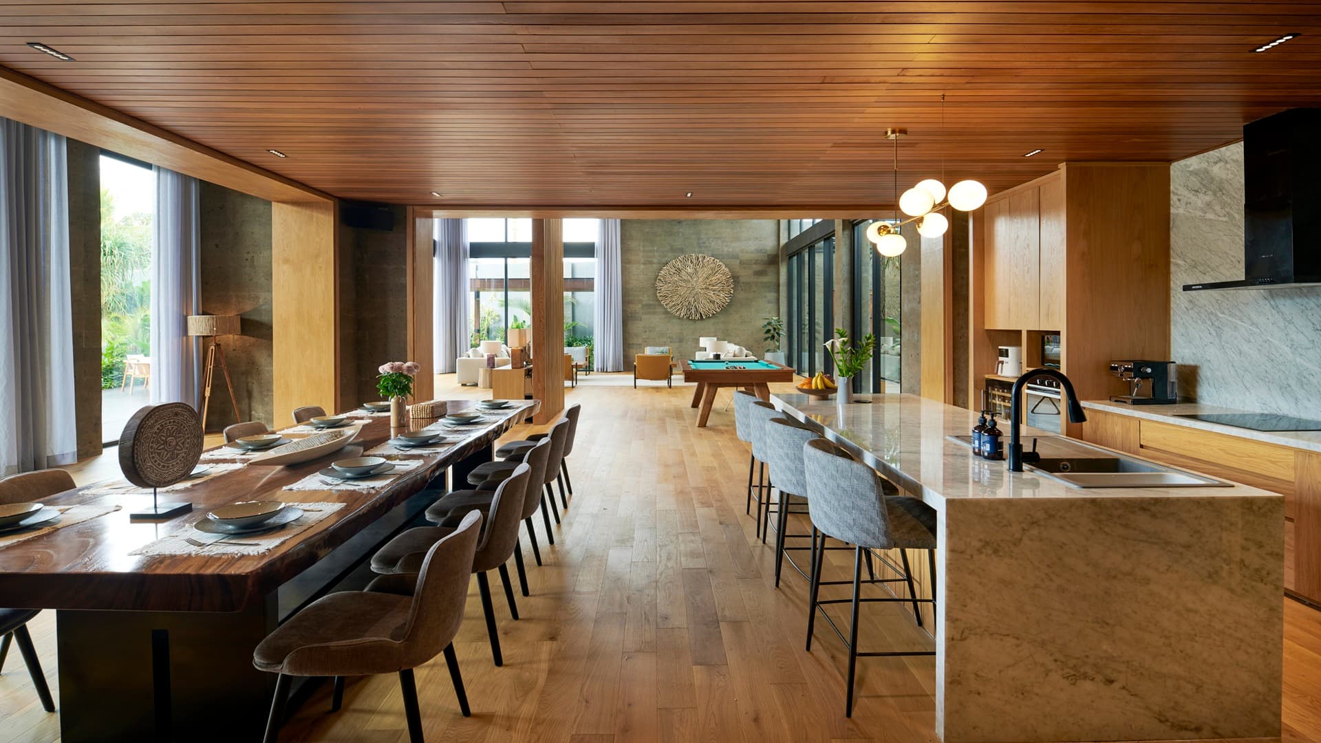The communal dining table and open-plan kitchen island